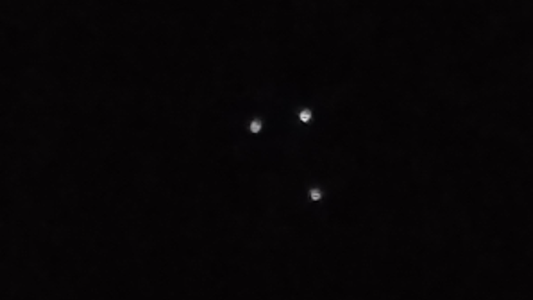 Black Triangle Sighting in Exmouth, England on 2017-04-17 21:41:00 - I was waiting for the bus while taking to a friend when i noticed 3 lights in a triangle pattern over the mouth of the river exe. took some video and pictures with my phone before the bus came and i left.